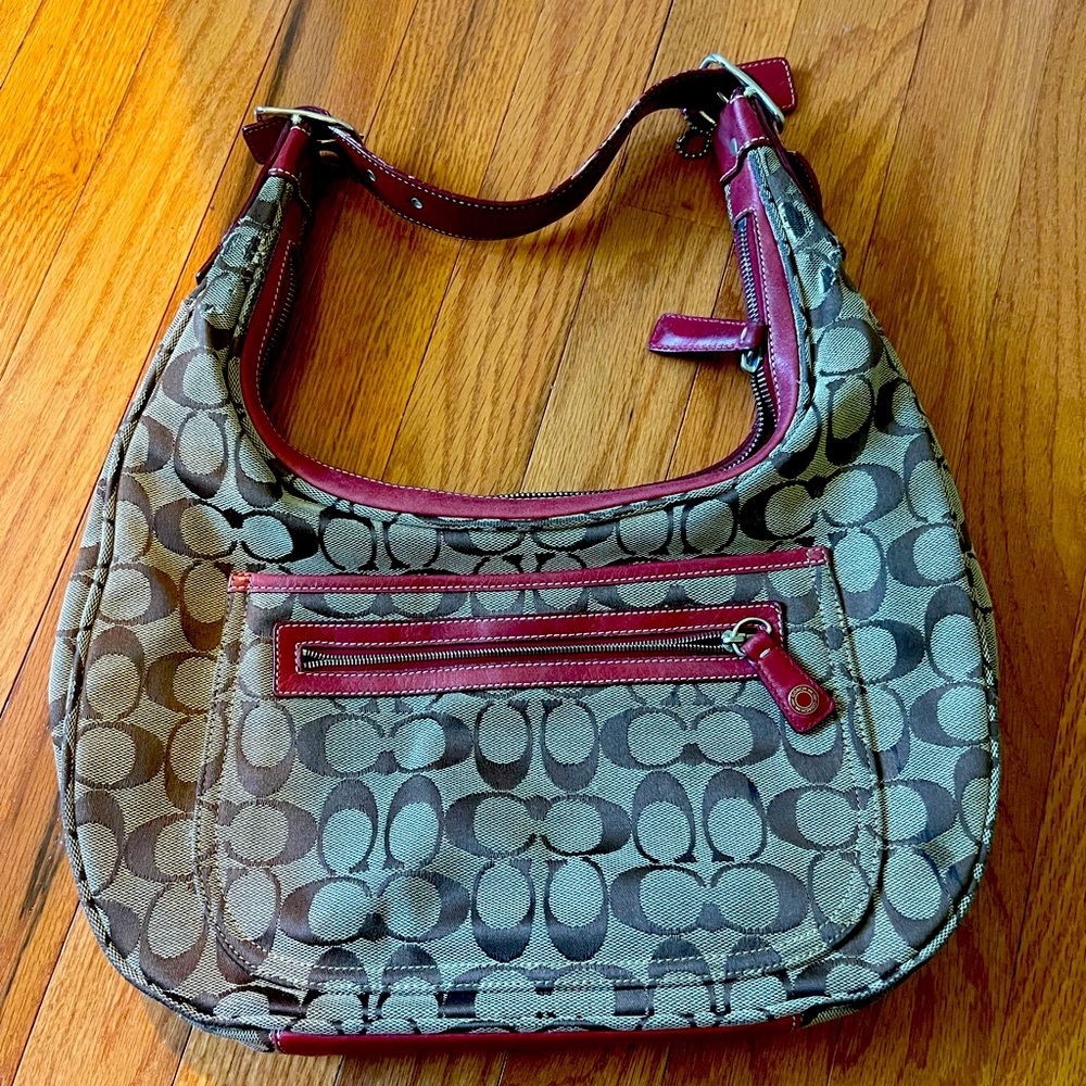 Coach bag in used condition.  Classic canvas with red leather detailing.